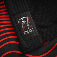 Skeleton label on the red and black striped lining of the black gi