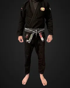 Front of Brent's black Murder Pajamas gi after 20 wash and dry cycles, worn and cropped at the collar, with his own gym chest patch and belt